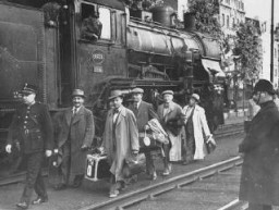 Belgium agreed to accept some of the Jewish refugee passengers of the St. Louis after Cuba and the US denied them entry. Here, Belgian police escort some of the passengers after their arrival in Antwerp. Belgium, June 17, 1939.