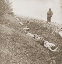 Execution of Polish prisoners of war near Ciepielow in September 1939. Some of the 300 Polish POWs who were executed here by firing squad are visible. In the background is a Wehrmacht soldier who participated. Ciepielow, Radom, Poland, September 1939. 