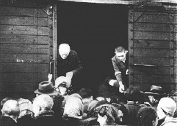 Jews being deported from the Warsaw ghetto board a freight train. Warsaw, Poland, July-September 1942.
