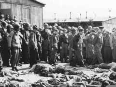 General Dwight D. Eisenhower and other American officers inspect conditions in the Ohrdruf concentration camp shortly after the liberation of the camp. As American forces had approached, SS camp guards shot the remaining prisoners before abandoning the camp. Confirmation of such atrocities prompted the US military to require Nazis and local German civilians to view the camps.