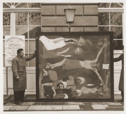 Art handlers at the Schloss Niederschoenhausen storage depot hold a section of Emil Nolde’s confiscated “Das Leben Christi,” 1937. The Nazi regime confiscated the work as "degenerate" art.