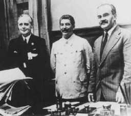 Nazi foreign minister Joachim von Ribbentrop (left), Soviet leader Joseph Stalin (center), and Soviet foreign minister Viacheslav Molotov (right) at the signing of the nonaggression pact between Germany and the Soviet Union. Moscow, Soviet Union, August 1939.