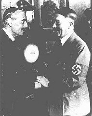 British prime minister Neville Chamberlain and German chancellor Adolf Hitler greet each other at the Munich conference. Munich, Germany, September 29-30, 1938.