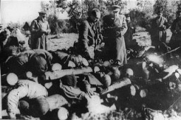 Soviet officials view stacked corpses of victims at the Klooga camp. Due to the rapid advance of Soviet forces, the Germans did not have time to burn the corpses. Klooga, Estonia, 1944.