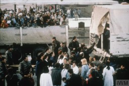 Refugee women and children arrive by truck in Tuzla during the Bosnian War, which lasted from 1992 to 1995. They are likely coming from Srebrenica. Photo taken in March 1993.