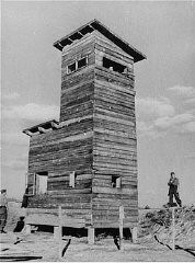 Ustasa (Croatian fascist) guard next to a watchtower at the Jasenovac concentration camp. Yugoslavia, between 1941 and 1944.