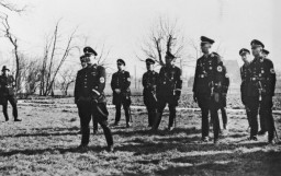 Scene during a visit by SS officer Theodor Eicke to the Lichtenburg camp in March 1936.
Lichtenburg was one of the first concentration camps established in Germany were established soon after Hitler's appointment as chancellor in January 1933. 
When SS chief leader Heinrich Himmler centralized the administration of the concentration camps and formalized the camp system, he chose SS Lieutenant General Theodor Eicke for the task. Himmler appointed him Inspector of Concentration Camps, a new section of the SS subordinate to the SS Main Office. Eicke had been the commandant of the  concentration camp at Dachau since June 1933.
