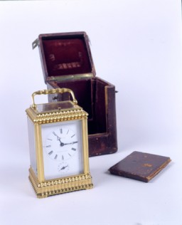 A seven-day gold traveling clock in a leather case, manufactured in France and originally made for a Russian nobleman. The panel in the leather case slides open to reveal the clock face. The clock was a Szepsenwol family heirloom. It was acquired by Chaya Szepsenwol's grandfather, who like her father, was a jeweler. The clock was among the family valuables that Rikla Szepsenwol was able to take out of Poland. [From the USHMM special exhibition Flight and Rescue.]