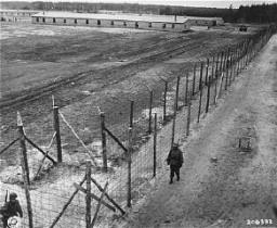 On May 2, 1945, the 8th Infantry Division and the 82nd Airborne Division encountered the Wöbbelin concentration camp. Here, American soldiers patrol the perimeter of the camp. Germany, May 4-May 10, 1945.