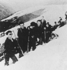 Jewish refugees from France and the Netherlands make their way from France into Spain through a pass in the Pyrenees mountain range. They are being rescued by "Dutch-Paris," an organization created by Seventh-day Adventist Johan Weidner. Ca. 1940.