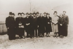 November 1938 group portrait of Jews of Polish nationality who were expelled from Nuremberg, Germany, to the Polish border town of Zbaszyn. The Jewish refugees were stranded on the border and were denied admission into Poland after their explusion from Germany.Pictured from left to right are: Leo Fallmann; Rosa Fallmann; Mr. Auerbach; Mr. Zahn; unknown; unknown; Chaim Kupfermann; Anni Kupfermann; Simon Wassermann; unknown; Regina Holzer; and Bertha Holzer.
 