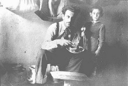 Mr. Mandil and his son Gavra, Yugoslav Jews, while in hiding. The Mandil family escaped to Albania in 1942. After the German occupation in 1943, Mandil's Albanian apprentice hid the family, all of whom survived. Albania, between 1942 and 1945.