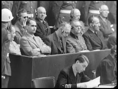 Defendant Hermann Göring, seated at left in the dock, listens as US Chief Prosecutor Robert Jackson interrogates witness Albert Kesselring about the Luftwaffe (German Air Force).