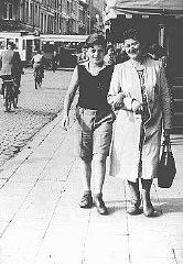 Shoshane Varmel Levy and her son, Jules, wearing the compulsory yellow badge, on a street in Antwerp. Belgium, June 1942.