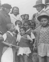 Henrietta Szold (left, in hat), founder of the Hadassah Women's Zionist Organization, welcomes some of the Polish Jewish refugee children known as the Tehran Children, upon their arrival in Palestine. Atlit, Palestine, February 18, 1943.