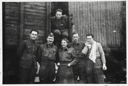 Six members of the Anders Army pose in front of a railcar prior to their departure for Iran. Krasnovodsk, Soviet Union, February 21, 1942.