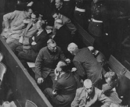 The defendants' box at the Nuremberg trial. Hermann Göring is seated at the far left of the first row. Nuremberg, Germany, 1945-1946.