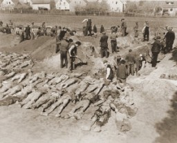 German civilians from Schwarzenfeld dig graves for the reburial of 140 Hungarian, Russian, and Polish Jews exhumed from a mass grave near the town. The victims died while on an evacuation transport from the Flossenbürg concentration camp. Schwarzenfeld, Germany, April 25, 1945.
Following the discovery of death march victims, US Army officers forced local Germans to view the scene of the crime and ordered the townspeople to give the victims a proper burial. 