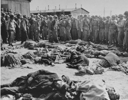 While touring the newly liberated Ohrdruf camp, General Dwight Eisenhower and other high ranking US Army officers view the bodies of prisoners who were killed during the evacuation of Ohrdruf. Ohrdruf, Germany, April 12, 1945.