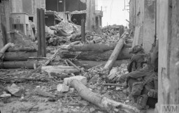 Canadian troops of the 'B' Company, North Shore (New Brunswick) Regiment take cover on June 6, 1944, or D-Day.