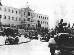 German troops drive in front of a government building during the occupation of Athens following the invasion of the Balkans. Athens, Greece, April 1941.