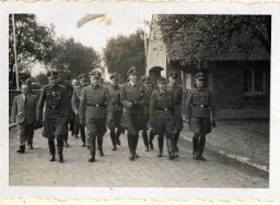 Walking to a ceremony; from left to right: Dr. Carl Clauberg, Dr. Enno Lolling, Karl Höcker (behind), Richard Baer, Dr. Eduard Wirths, Karl Bischoff (behind Wirths on the right) Rudolf Höss, and Karl Möckel.
