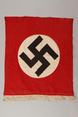 Nazi banner with a swastika. The swastika became the most recognizable symbol of Nazi propaganda, appearing on the Nazi flag, election posters, arm bands, medallions, and badges for military and other organizations.