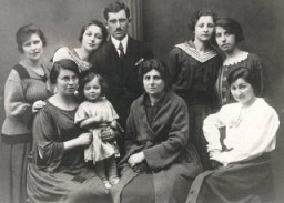 Laks family photo, Poland, ca. 1925. Sitting, left to right: Pola Laks (Regina's mother) with baby Hania, grandmother Sara Tennenblum, Aunt Andzia Tennenblum. Standing, left to right: Aunt Lodzia Laks, Aunt Regina Tennenblum, Izak Laks (Regina's father), Aunt Rozia Tennenblum, and Aunt Dora Laks.