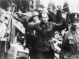 Soldiers from the Kiliński Battalion of the Polish Home Army take a German prisoner during the Warsaw Polish uprising. August 20, 1944.