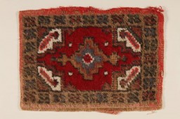 This small patterned hooked rug was used as a shoe mat in the wagon of Rita Prigmore and her family when she was a child in Wurzberg, Germany, after World War II. Rita and her family were members of the Sinti group of Roma (Gypsies). She and her twin sister Rolanda were born in 1943. Rolanda died as a result of medical experiments on twins in the clinic where they were born. Rita was returned to her family in 1944. She and her mother survived the war and moved to the United States, before returning to Germany to run a Sinti human rights organization that sought to raise consciousness about the fate of Roma during the Holocaust.