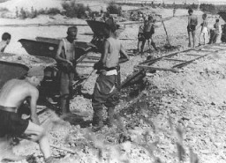 Conscripts of Hungarian Labor Service Company VIII/2 at work laying railroad track. Huszt, Hungary, 1942.