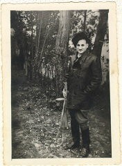 Aron Derman while he was with Polish partisans in 1944. In this photograph, Aron wears a fur hat that he made and boots that he finished himself (he found them in the ghetto, unfinished, and sewed them up). Lisa Nussbaum was also a member of the partisans. Aron recounted that for a short while, Lisa was in charge of 200 women. Photograph taken in 1944, in a partisan base in the Naroch forest.