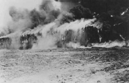 Buildings of the Bergen-Belsen concentration camp is burned to the ground to halt the spread of typhus. Germany, May 21, 1945.