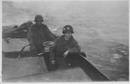 Two American soldiers cross the Rhine River into Germany on March 29, 1945. In the foreground is Jack Caminer, who emigrated from Germany to the United States in 1938. After he was drafted into the US Army, Caminer was sent to Camp Ritchie to prepare for intelligence work. Caminer participated in the liberation of Ohrdruf.  