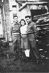 A Jewish Brigade soldier with two members of "Kibbutz Buchenwald." "Kibbutz Buchenwald" was a group of survivors from the Buchenwald concentration camp who were preparing for agricultural work in Palestine. Antwerp, Belgium, 1946.