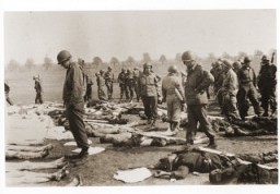 American soldiers view the bodies of prisoners laid out in rows in an open field at Ohrdruf, a subcamp of Buchenwald in Germany. [LCID: 38099]