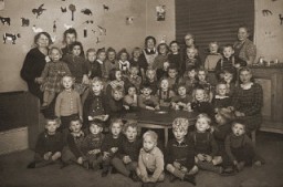 Portrait of a preschool class in Copenhagen. Gus Goldenburger (top row, second from left) was one of the few Jewish students in the class. His family moved to Denmark from Czechoslovakia, fearing the rising tide of Nazism. When the Nazis planned to deport Danish Jewry, the Goldenburgers managed to escape to Sweden, where they remained until the end of the war. After the war, the Goldenburgers returned to Copenhagen. Photograph taken in Copenhagen, Denmark, 1938–1939.