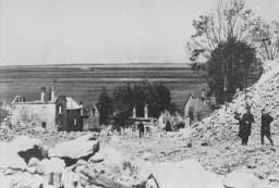 SS officers stand among the rubble of Lidice during the demolition of the town's ruins in reprisal for the assasination of Reinhard Heydrich. Czechoslovakia, between June 10 and June 30, 1942.