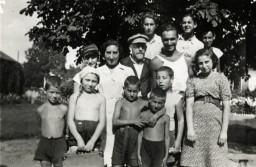 Janusz Korczak (center) and Sabina Lejzerowicz (to his right) pose with children and younger staff in Korczak's orphanage in Warsaw, circa 1930-1939. Even as they were deported to their deaths at Treblinka in 1942, Korczak and his staff stayed by their children.