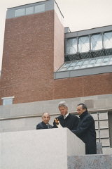 President Bill Clinton (center), Elie Wiesel (right), and Harvey Meyerhoff (left) light the eternal flame outside on the Eisenhower ...