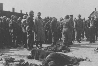 Generals Eisenhower, Patton, and Bradley view corpses of inmates at Ohrdruf, a subcamp of Buchenwald.