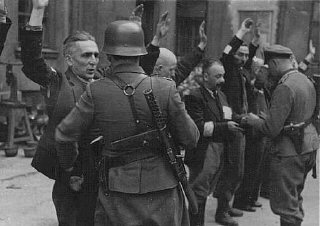 German soldiers arrest Jews during the Warsaw ghetto uprising.