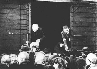 Jews being deported from the Warsaw ghetto board a freight train.