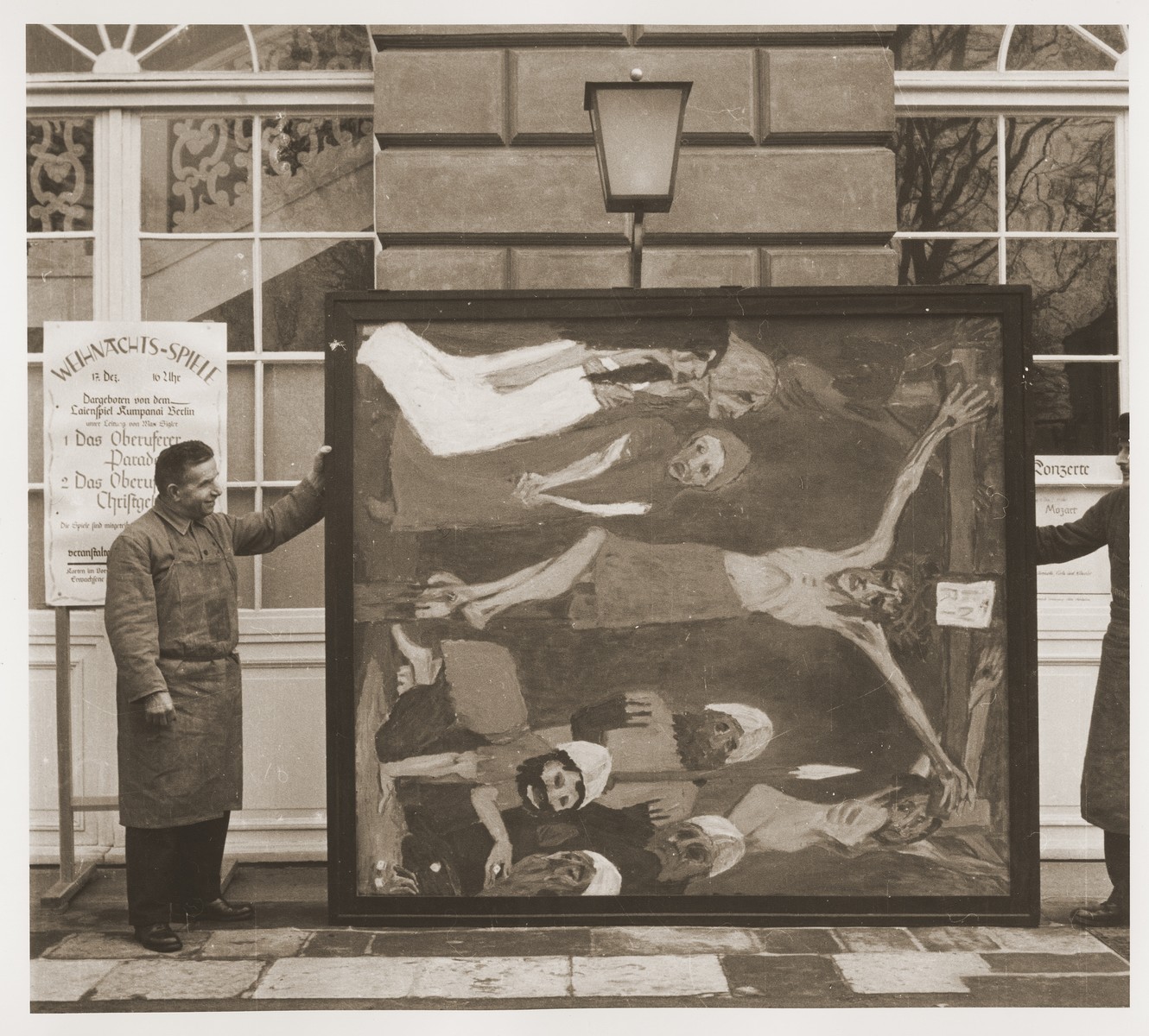 Art handlers hold a confiscated artwork by Emil Nolde
