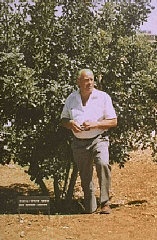 Oskar Schindler next to the tree planted in his honor