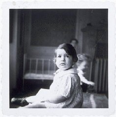 A young girl in a home for Jewish infants waiting for their families to claim them or be adopted.