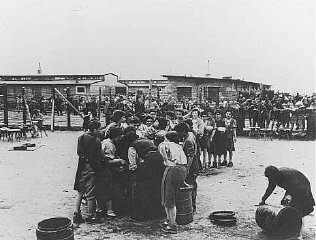After liberation by US troops, former prisoners wait in line for soup.